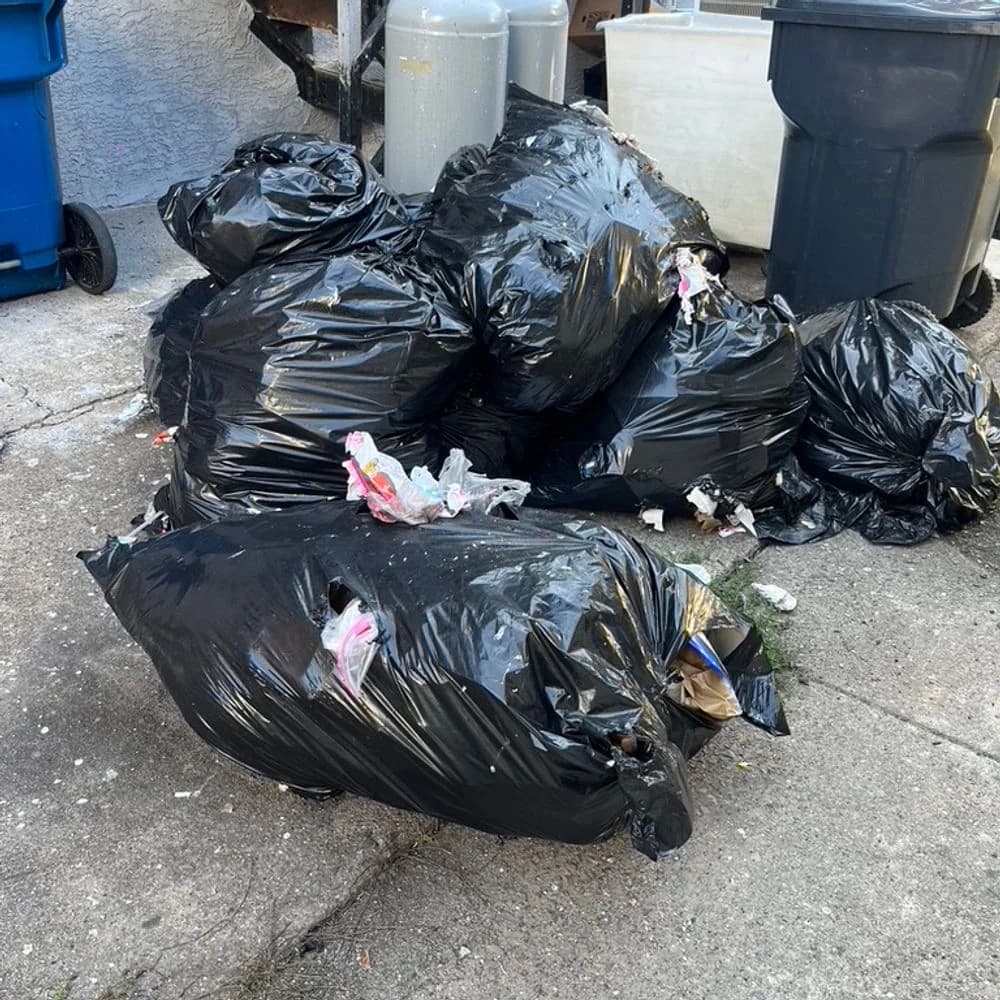 Bagged household trash collected on a T Maxwell recurring pickup route